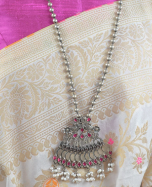 The dashing silver pendant along with long silver beads chain is beyond beautiful, especially the pearl on the bottom, perfect for ladies. It's charming pendant with pink stone will give you intricate and elegance to your look When you will carry it.