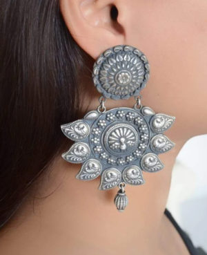 Admiring silver earrings